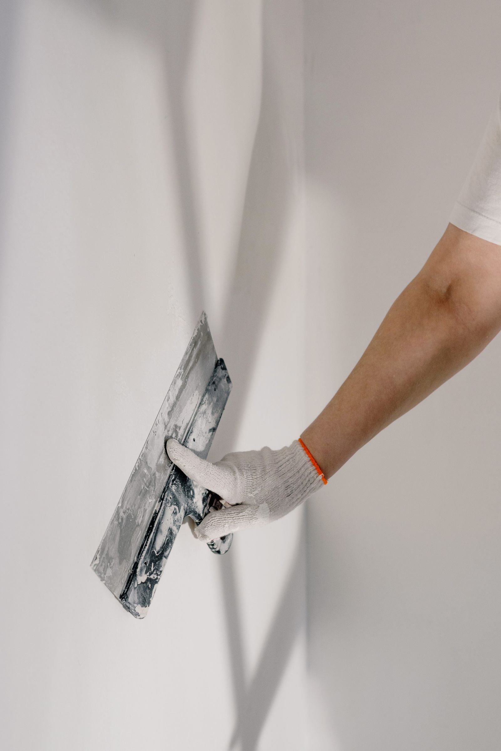 Drywall finisher smoothing joint compound on an interior wall